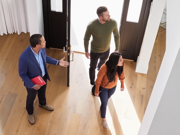 Zillow agent touring the inside of a home with customers
